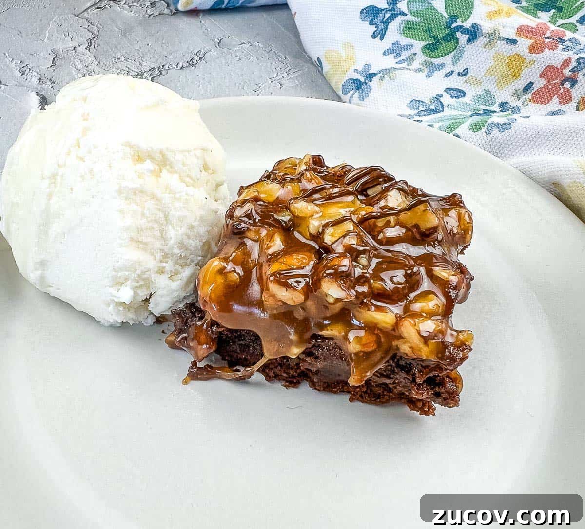 33 Irresistible Fall Desserts That Defy Portion Control 20 A piece of Turtle Brownie with ice cream on a plate.