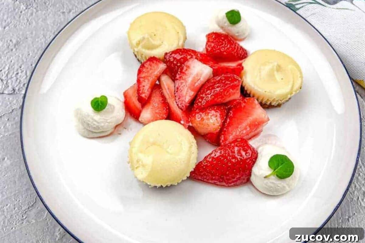 33 Irresistible Fall Desserts That Defy Portion Control 26 A white plate with strawberries and mini biscoff cheesecakes.