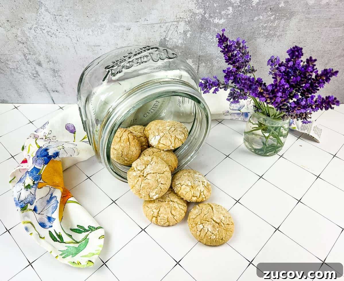 33 Irresistible Fall Desserts That Defy Portion Control 27 A jar of White Chocolate Crinkle Cookies next to lavender flowers.