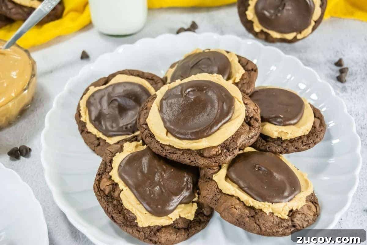 33 Irresistible Fall Desserts That Defy Portion Control 4 A plate with several Crumbl Copycat Buckeye brownie cookies topped with a layer of peanut butter and a swirl of chocolate frosting.