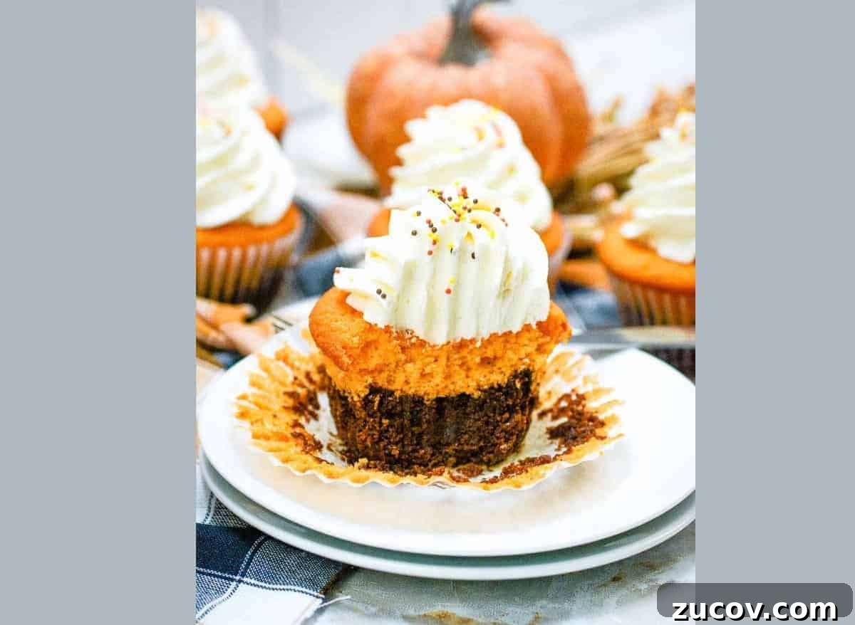 33 Irresistible Fall Desserts That Defy Portion Control 8 Fall brownie cupcakes with whipped cream on a plate.