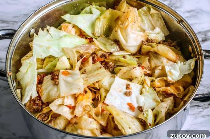 Unstuffed Cabbage Roll Casserole Recipe – One-Pan Comfort Meal 5 shredded cabbage and ground beef in pot