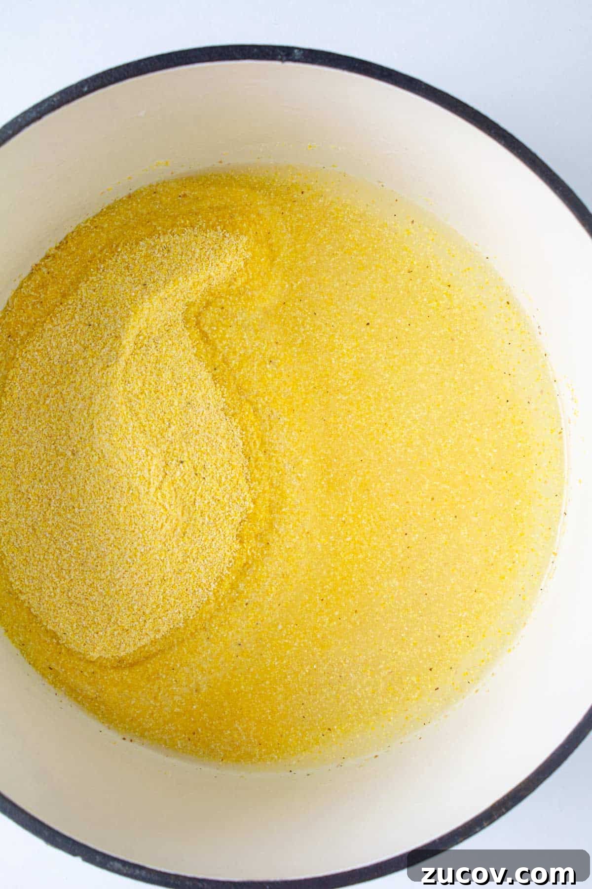 Creamy Polenta with Caramelized Onions and Sautéed Peppers 4 Cornmeal and water in a Dutch oven ready to cook.