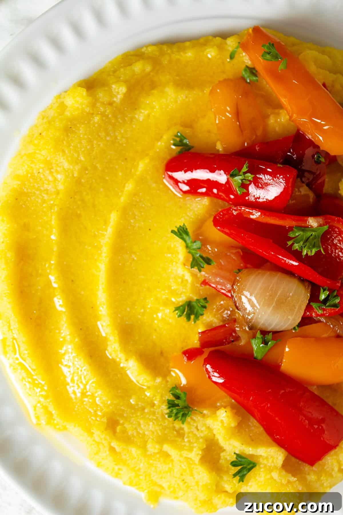 Creamy Polenta with Caramelized Onions and Sautéed Peppers 7 A close up of soft polenta with caramelized onions and peppers.