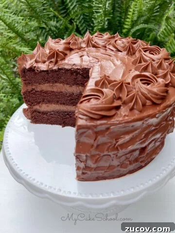 Chocolate Mousse Cake, sliced, on a cake pedestal.