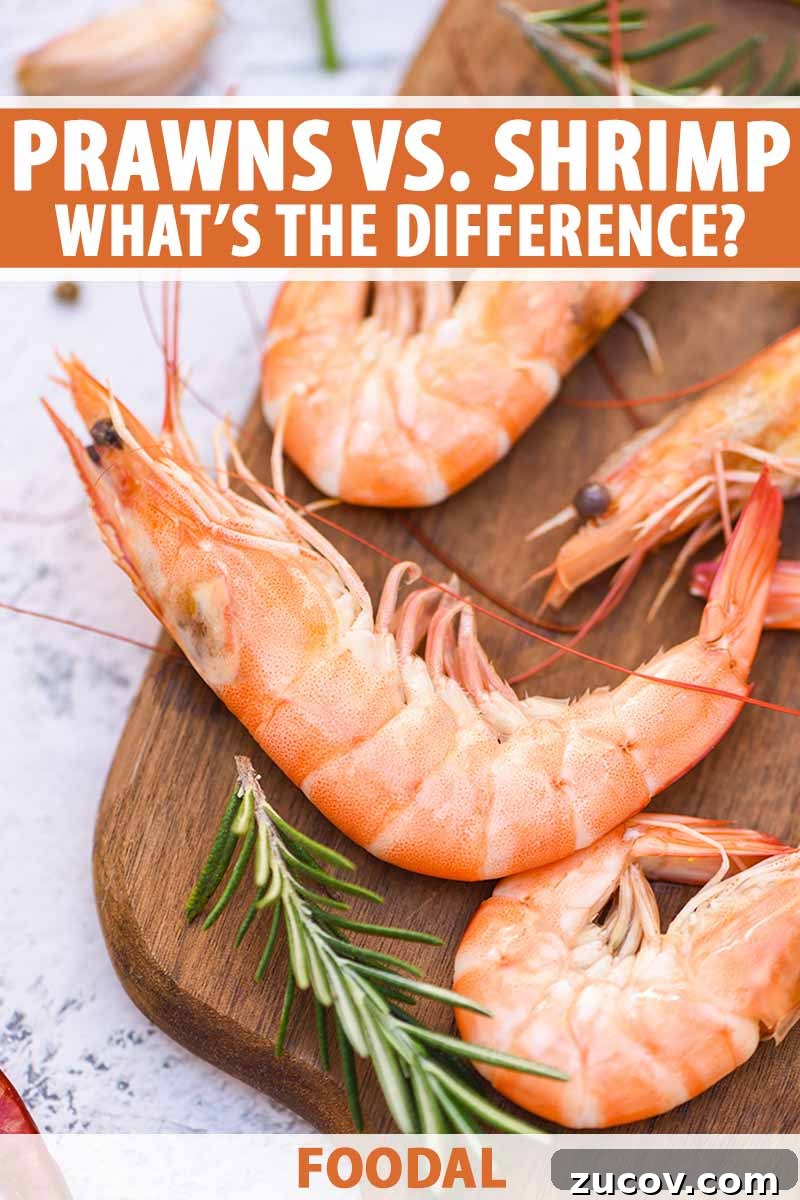 Prawns vs Shrimp: Key Differences, Uses, and How to Tell Them Apart 2 Vertical image of cooked whole prawns on a wooden cutting board next to rosemary, with text on the top and bottom of the image.