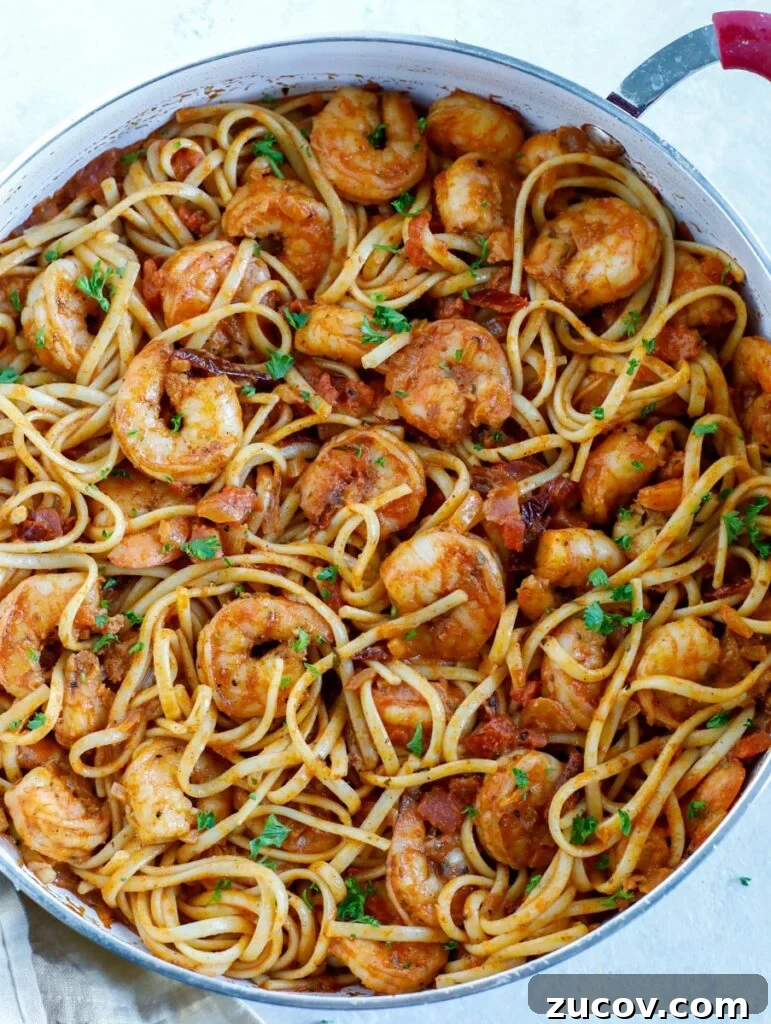 Creamy Spicy Shrimp Pasta with Garlic and Chili Oil 5 Top down shot of shrimp pasta in a skillet.