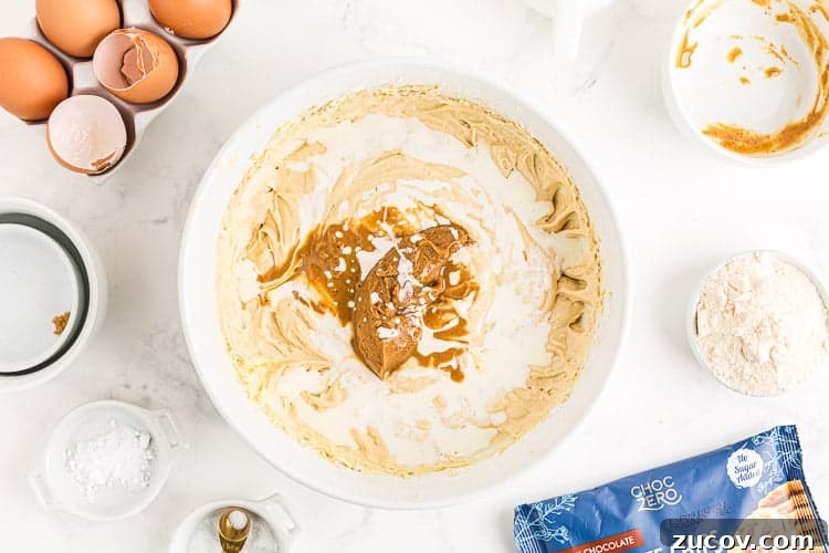 Keto Peanut Butter Chocolate Chip Cookie Recipe 4 overhead view of bowl containing cookie batter and peanut butter