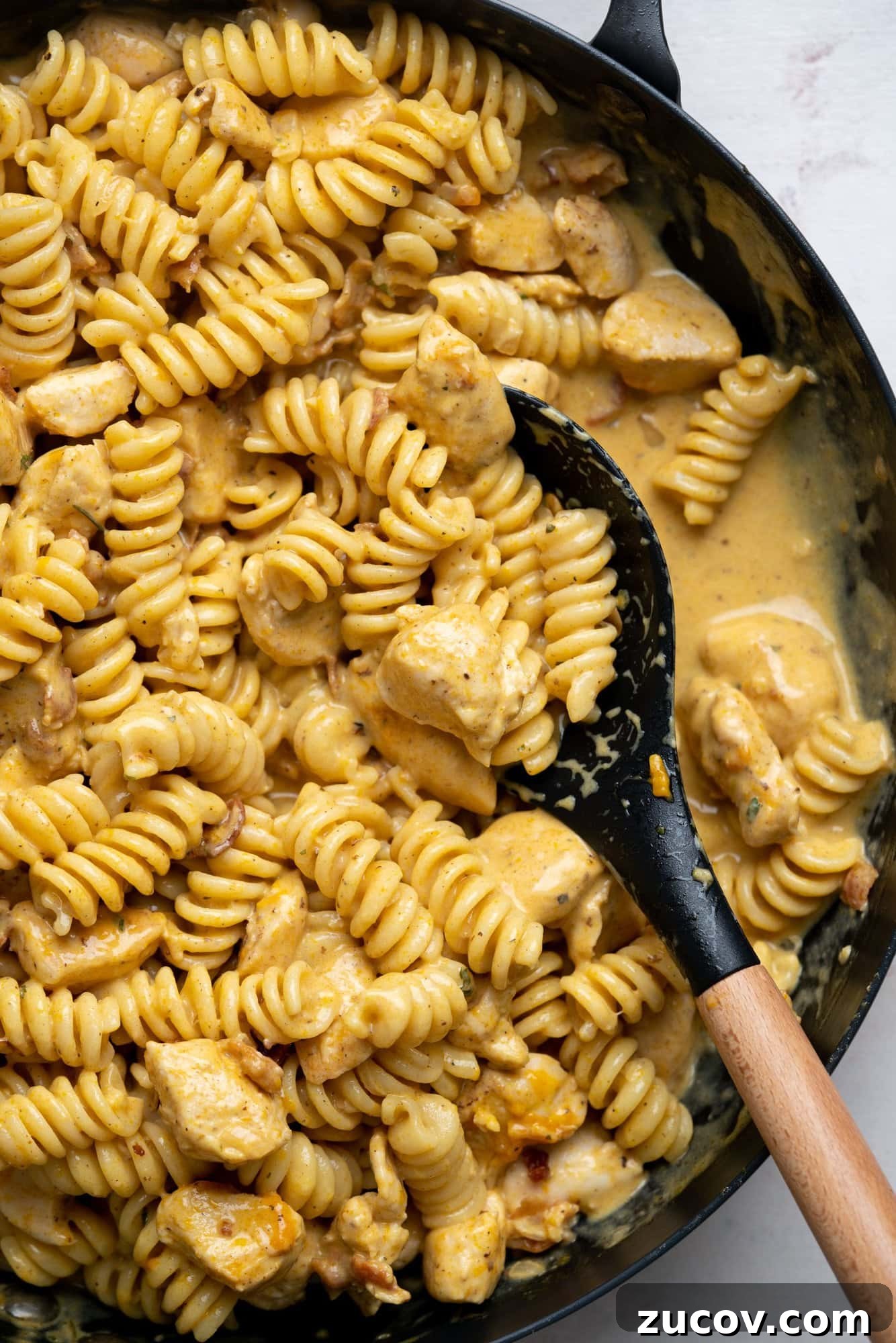 Creamy Chicken Bacon Ranch Pasta Recipe for Weeknight Dinners 2 Chicken pasta made with a creamy cheesy sauce with ranch seasoning in a skillet.