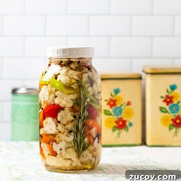 Crisp Quick Pickled Asparagus Recipe for Flavorful Snacks 4 Jar of pickles with a rosemary sprig.