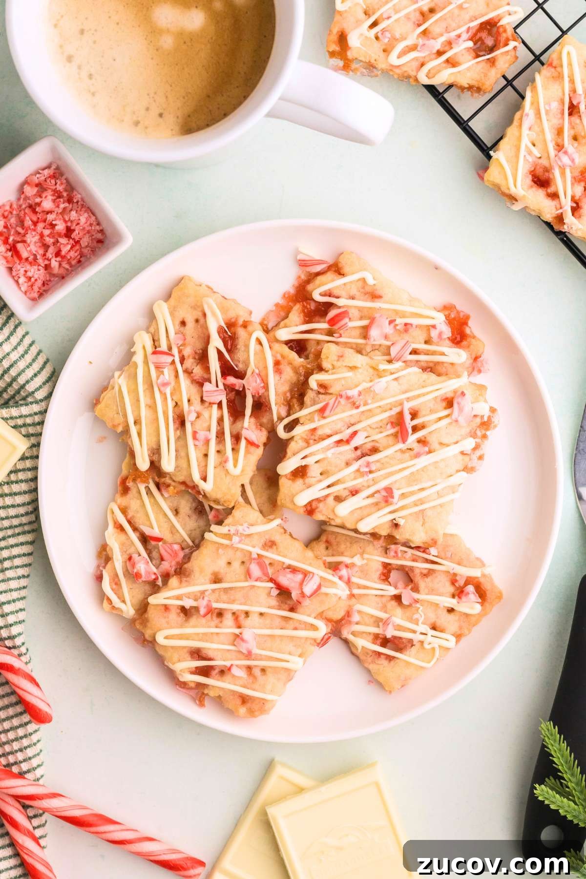 Peppermint Shortbread Cookies with White Chocolate Drizzle Recipe 2 Plate of peppermint shortbread cookies drizzled with white chocolate.