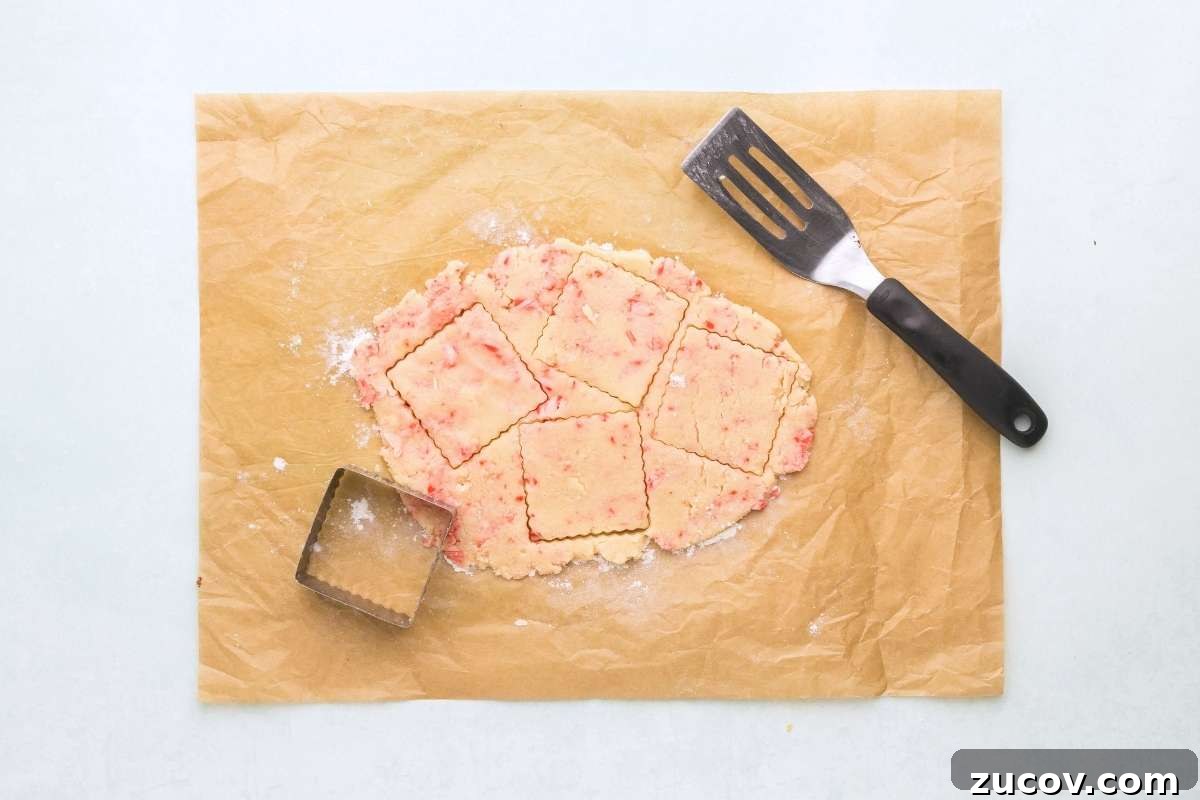 Peppermint Shortbread Cookies with White Chocolate Drizzle Recipe 7 Peppermint dough rolled out and cut into squares with a cookie cutter.