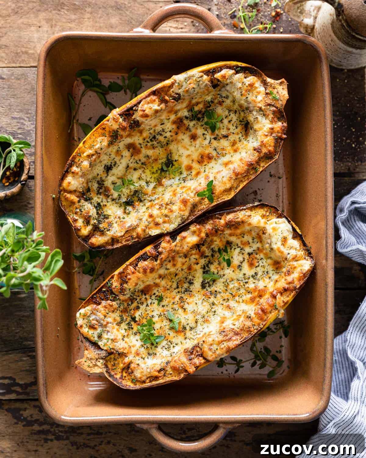 Crispy Air Fryer Spaghetti Squash Recipe — Quick & Flavorful 2 Air fried spaghetti squash in a brown casserole dish.