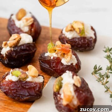 Stuffed dates drizzled with honey on table.
