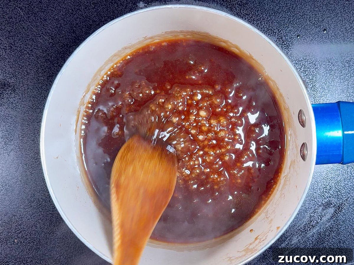 Sticky Honey Garlic Chicken Wings Recipe for Crispy Oven-Baked Wings 7 Boiling the reserved honey garlic sauce in a saucepan until thickened.