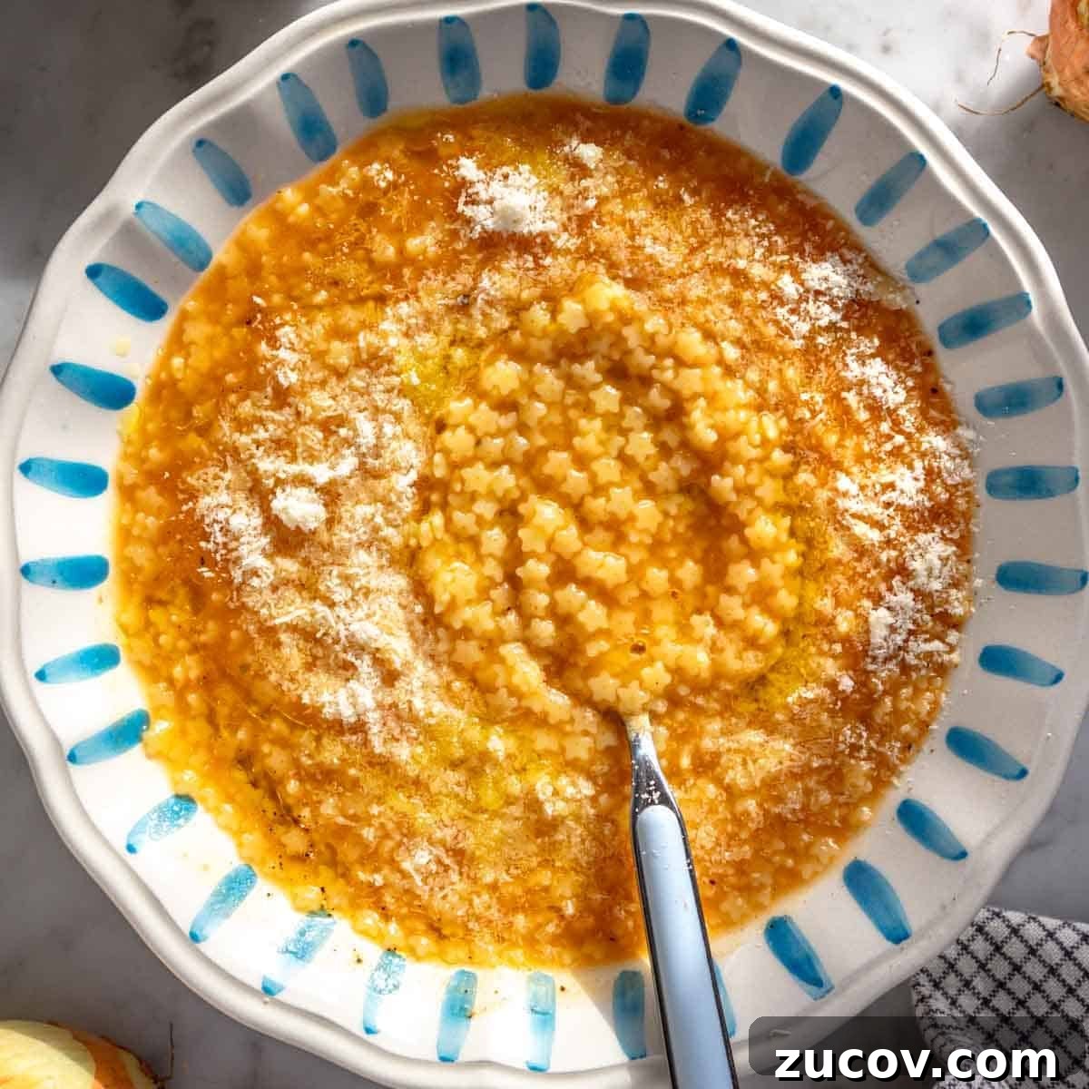25 Affordable Recipes That Taste Gourmet on a Budget 17 Pastina soup with parmesan in a bowl.