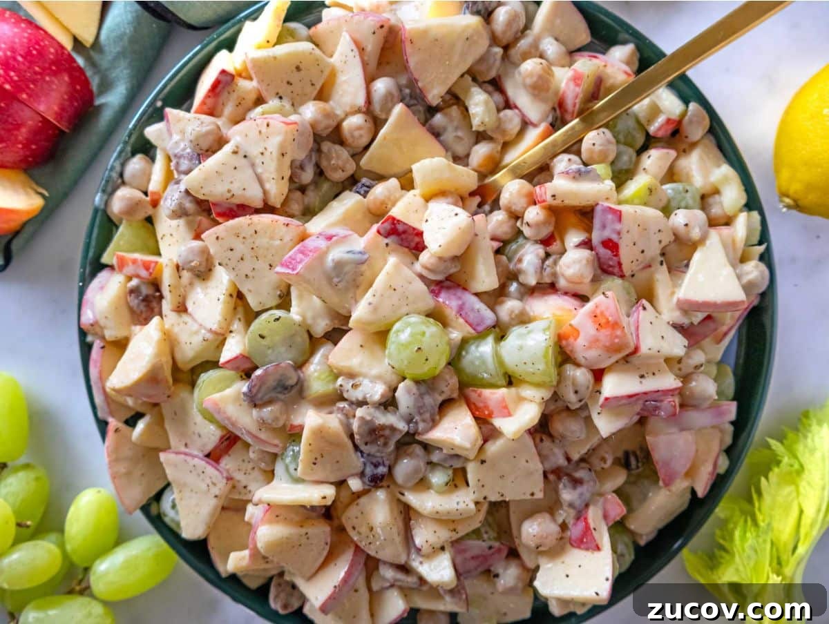 25 Affordable Recipes That Taste Gourmet on a Budget 7 Fresh apple chickpea salad with grapes pecans and chickpeas in white bowl.