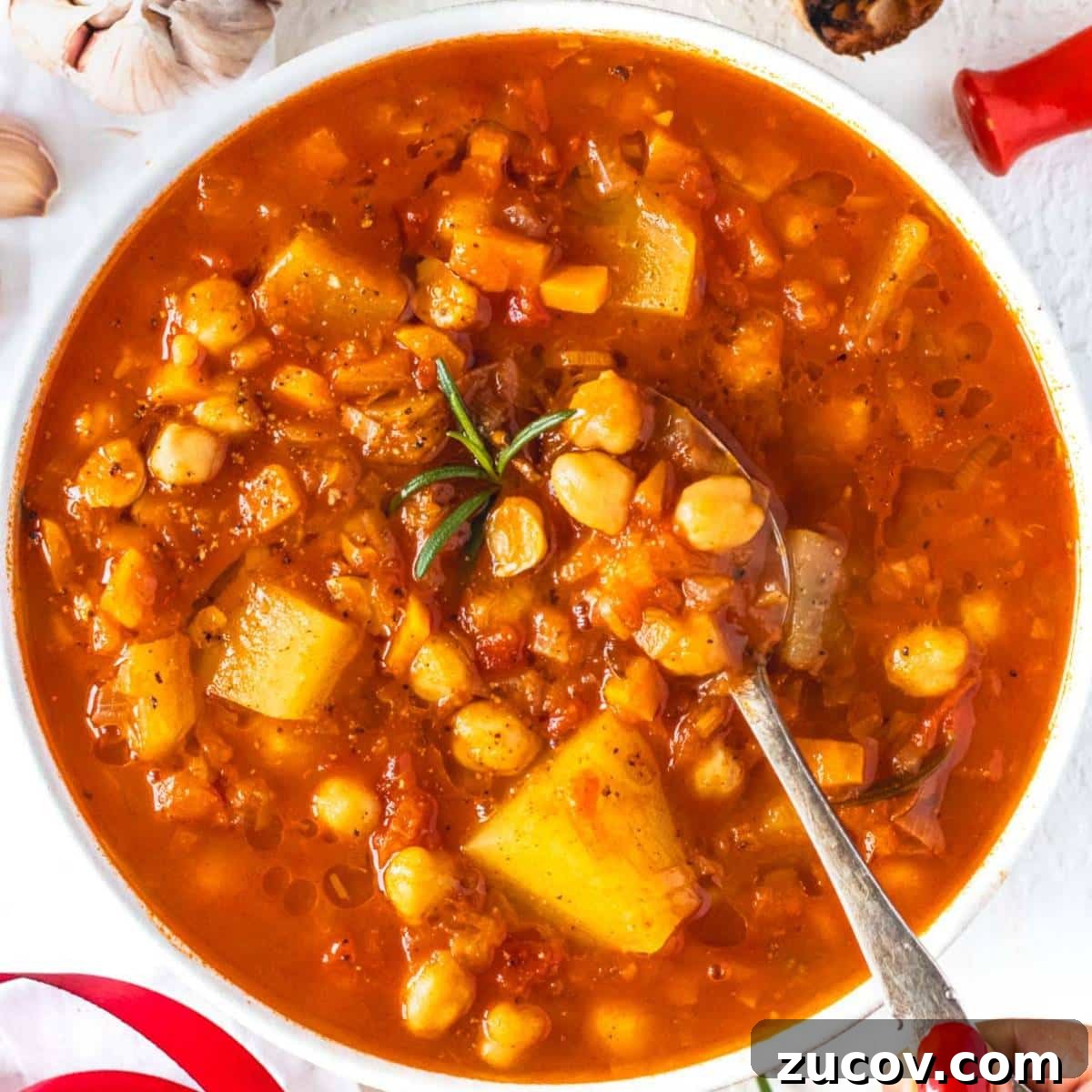 25 Affordable Recipes That Taste Gourmet on a Budget 9 Rustic Mediterranean chickpea soup in a white bowl ready for a cozy healthy dinner.