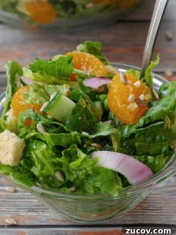 Mandarin Orange salad in a small glass bowl with a fork