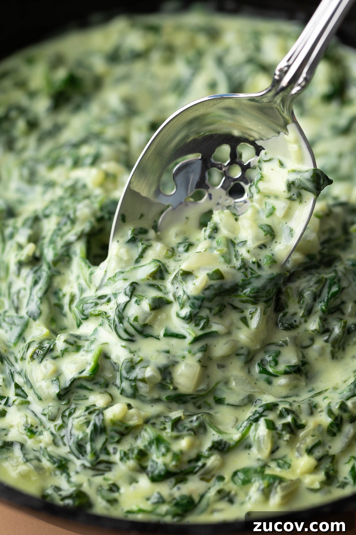 Silky Creamed Spinach Recipe: Quick Side Dish for Any Meal 2 spoonful of creamed spinach recipe in a cast iron skillet