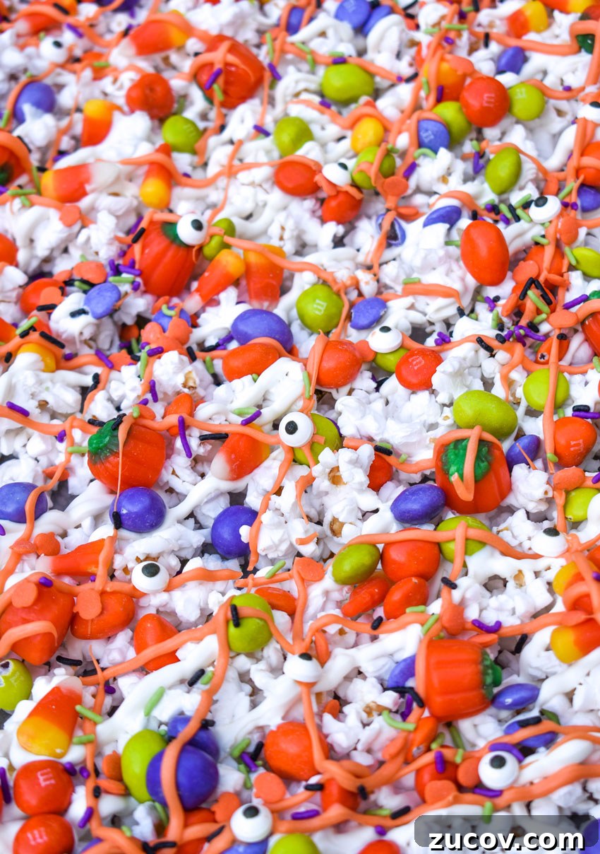 Monster Munch Snacks: Flavor Guide, Variants & Where to Buy 4 monster halloween popcorn mix on a sheet of parchment paper