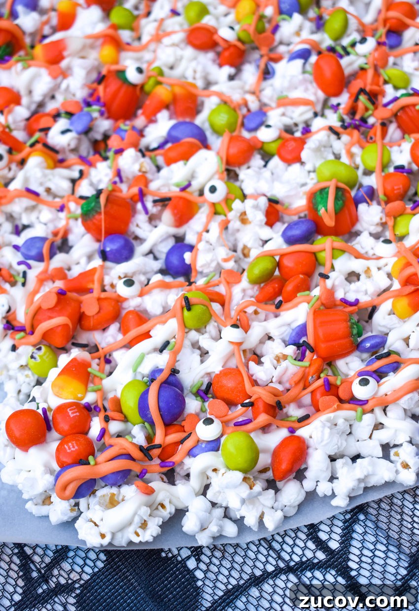 Monster Munch Snacks: Flavor Guide, Variants & Where to Buy 5 monster halloween popcorn mix on a sheet of parchment paper