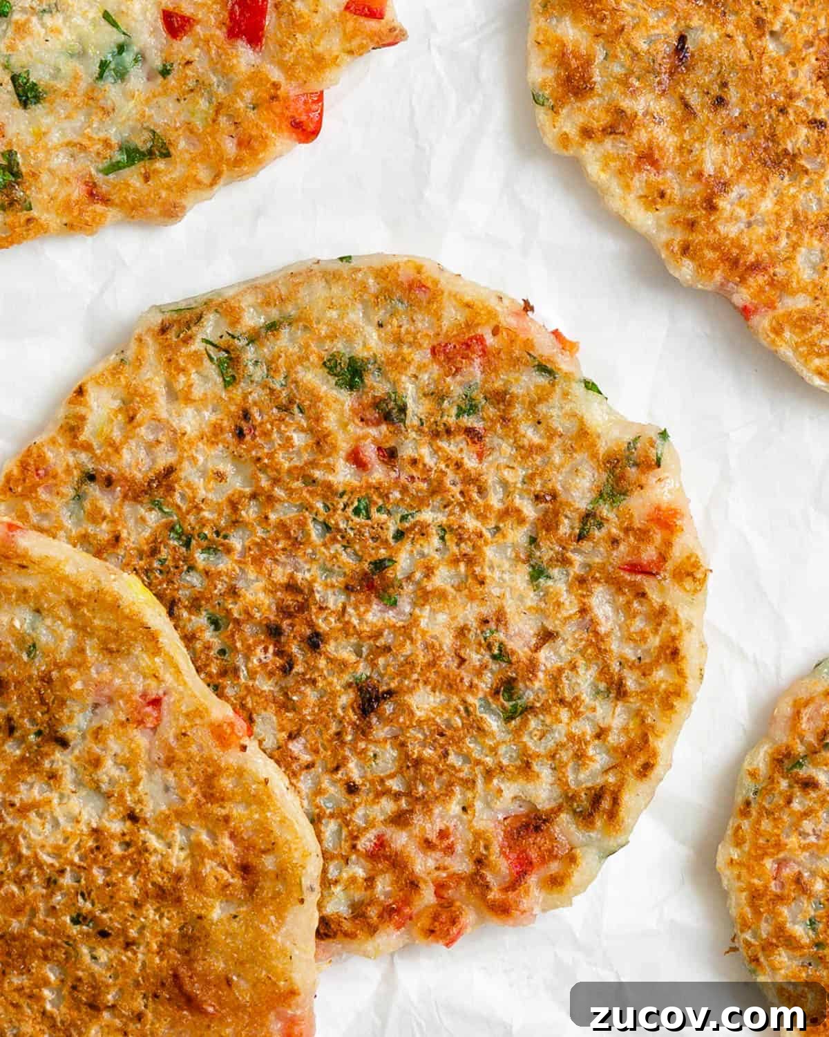 Crispy Vegan Potato Pancakes Recipe for Breakfast & Brunch 2 completed Vegan Potato Pancakes against a white surface