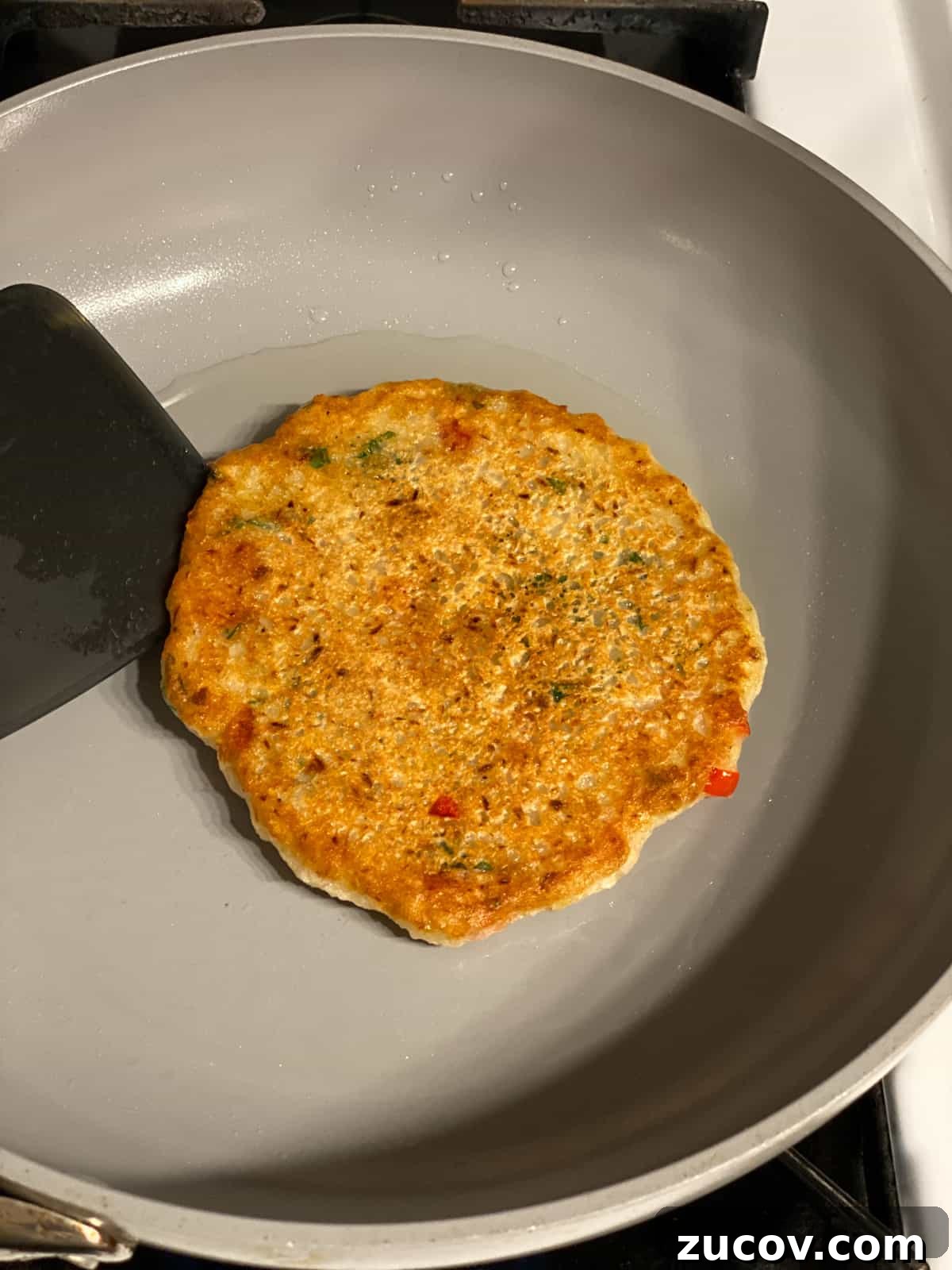 Crispy Vegan Potato Pancakes Recipe for Breakfast & Brunch 10 process shot post flipping pancake in a pan