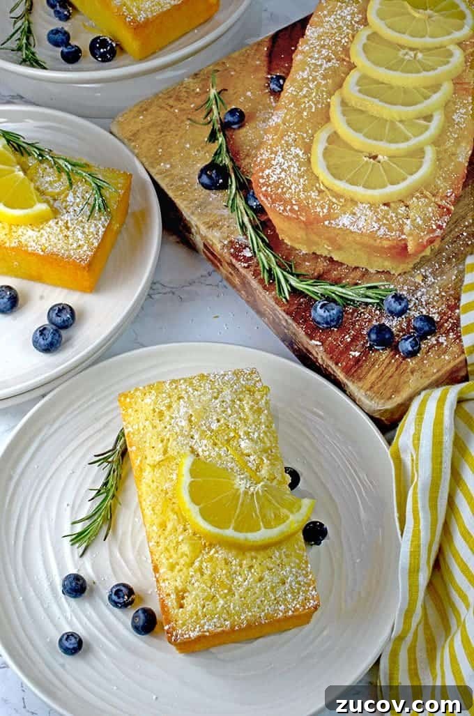 Rosemary Lemon Loaf with Silky Lemon Icing 2 A bunch of lemon loaf cake on a cutting board