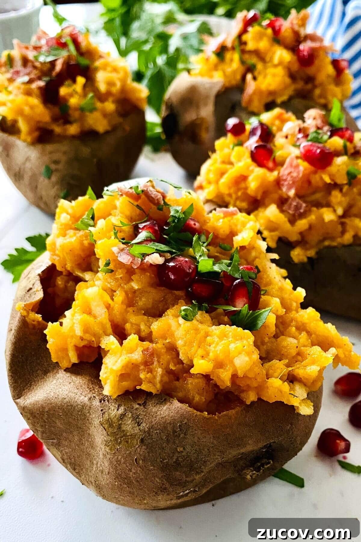 Apple and Bacon Stuffed Sweet Potatoes: Savory Autumn Recipe 2 2 stuffed sweet potatoes topped with pomegranate arils.
