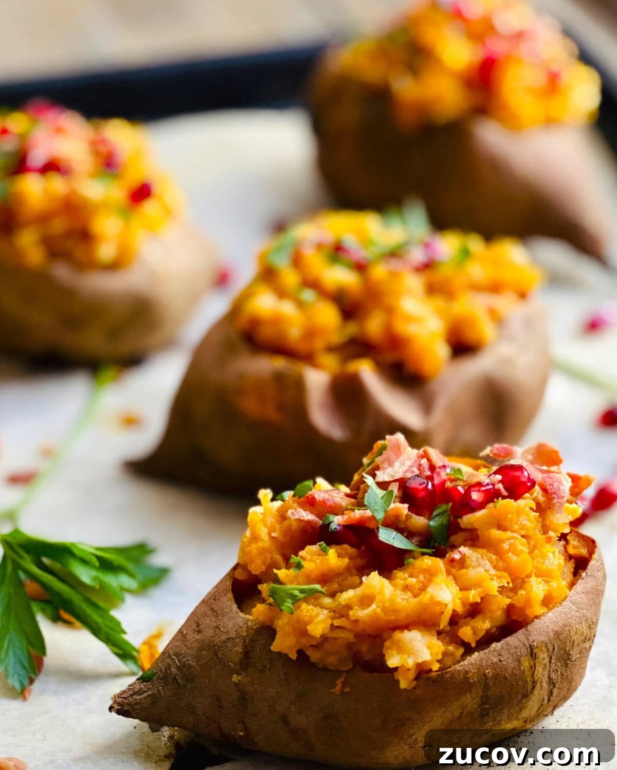 Apple and Bacon Stuffed Sweet Potatoes: Savory Autumn Recipe 11 Four apple stuffed sweet potatoes on a baking sheet.