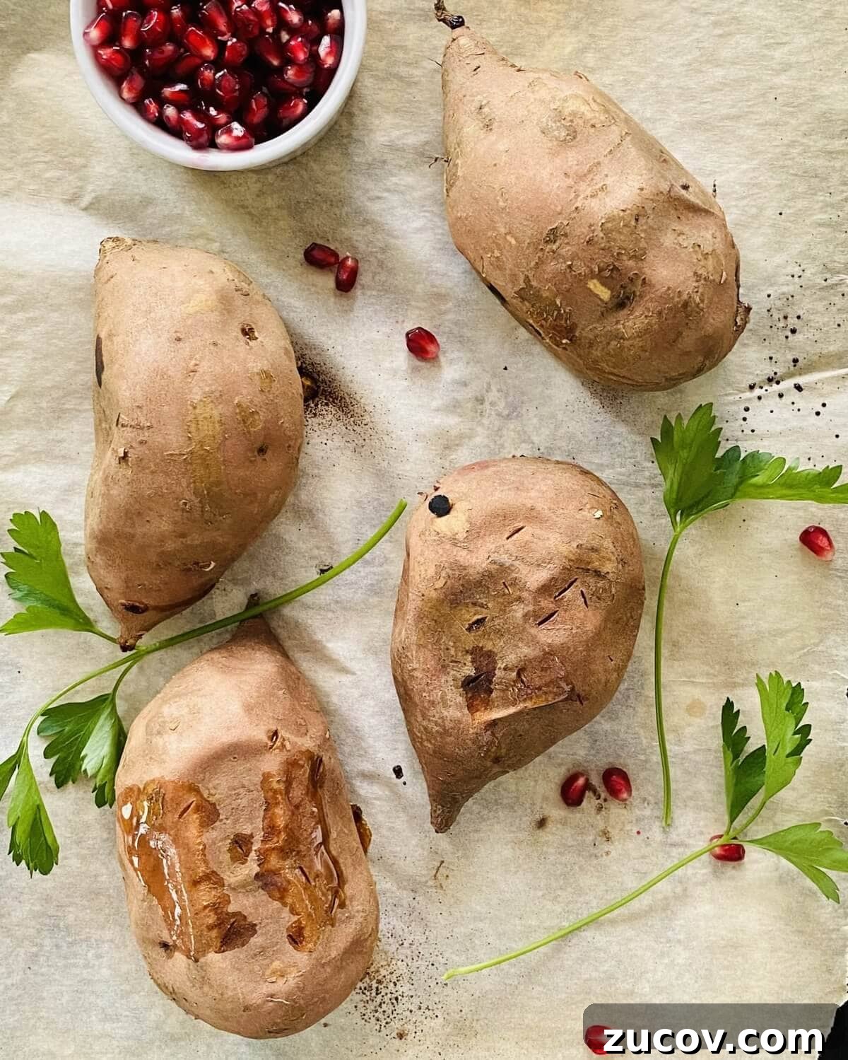 Apple and Bacon Stuffed Sweet Potatoes: Savory Autumn Recipe 4 Baked sweet potatoes on parchment paper.
