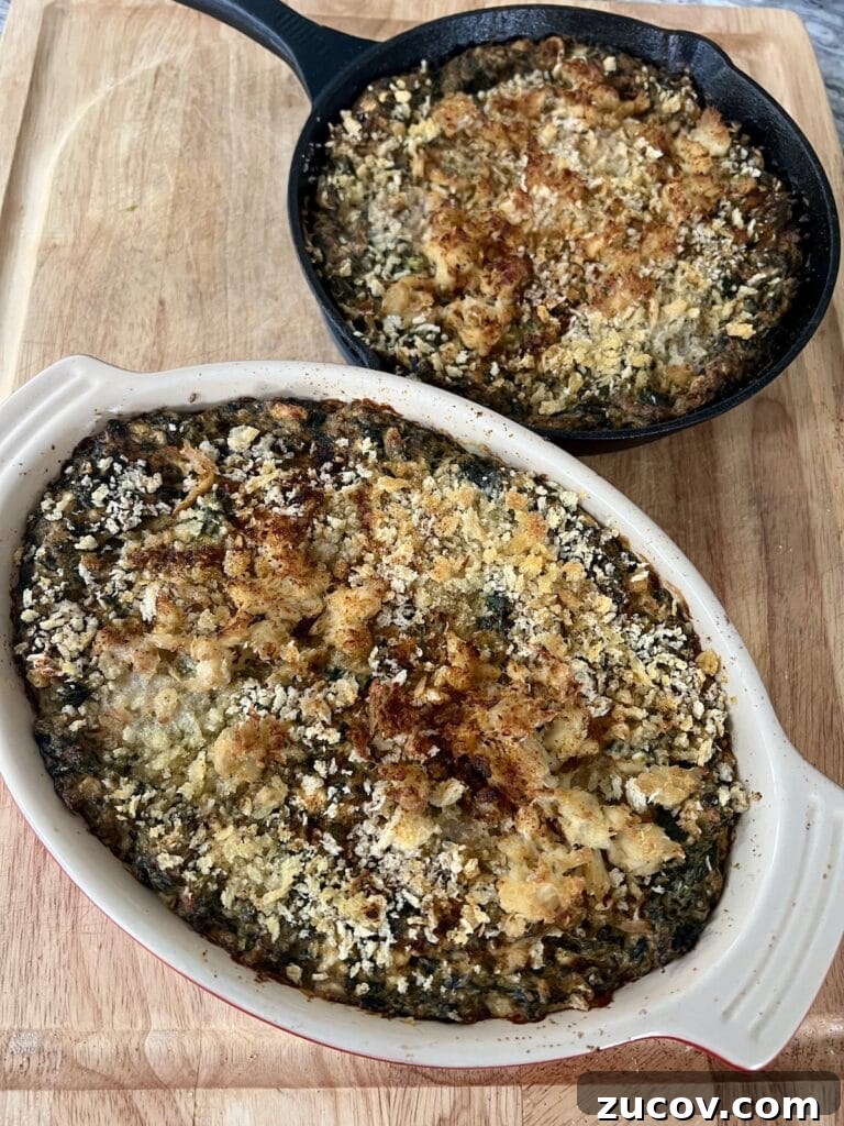 Creamy Baked Crab and Spinach Dip for Parties and Game Day 10 Finished baked dips in baking dish and cast iron pan on cutting board.