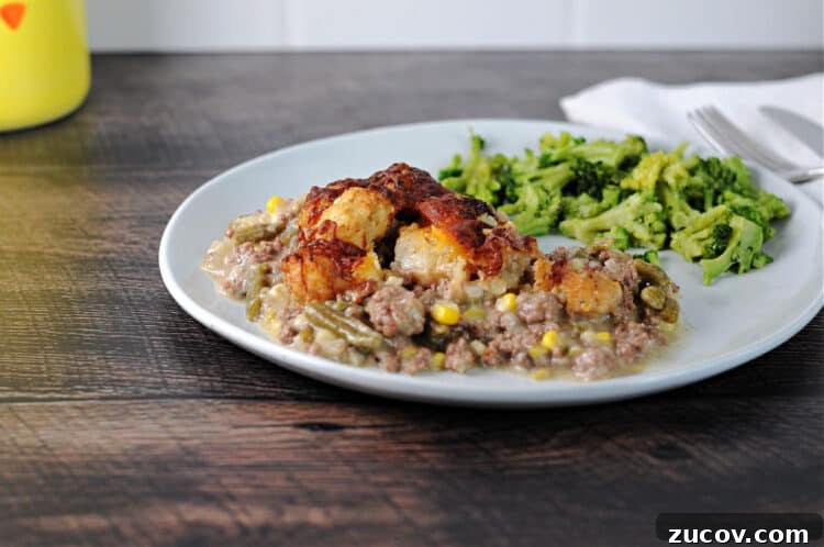Cheesy Tater Tot Casserole Made in the Instant Pot 2 serving of instant pot tater tot casserole on a plate with broccoli.