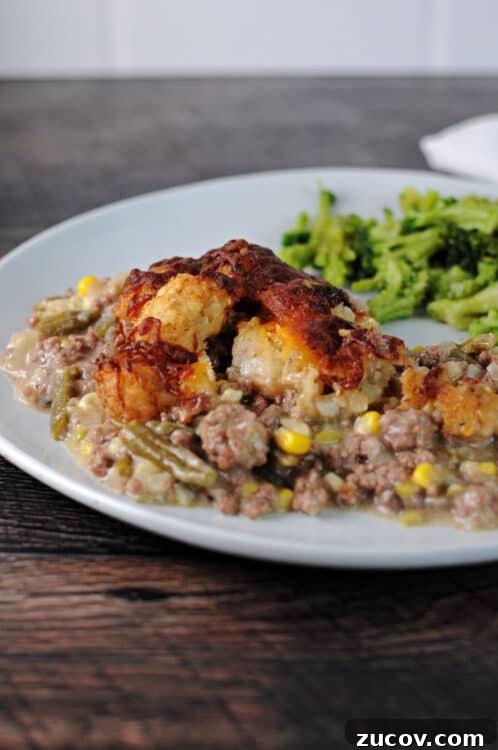 Cheesy Tater Tot Casserole Made in the Instant Pot 8 serving of tater tot cassserole on a plate.