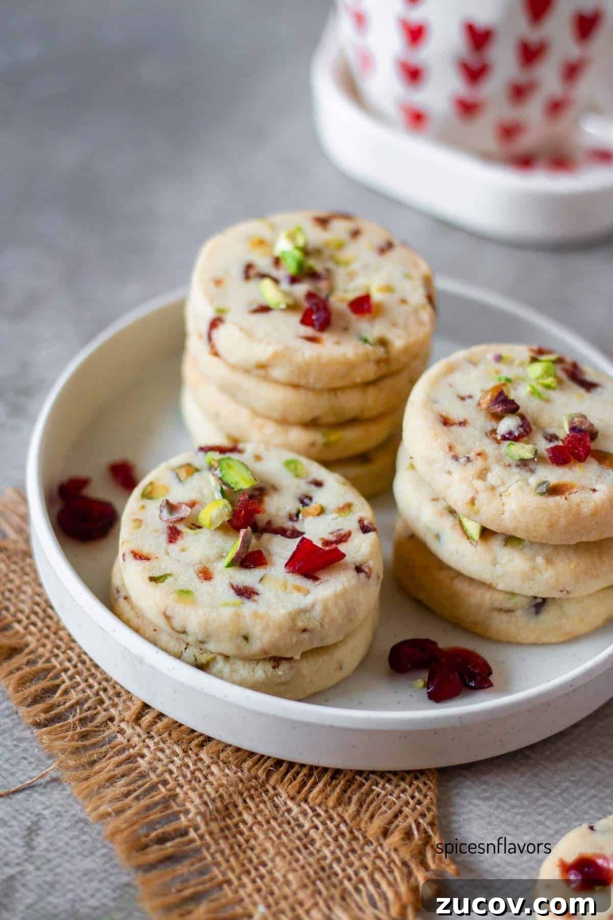 Cranberry Pistachio Shortbread Cookies (Egg-Free) 8 cranberry pistachio cookies placed on a white plate