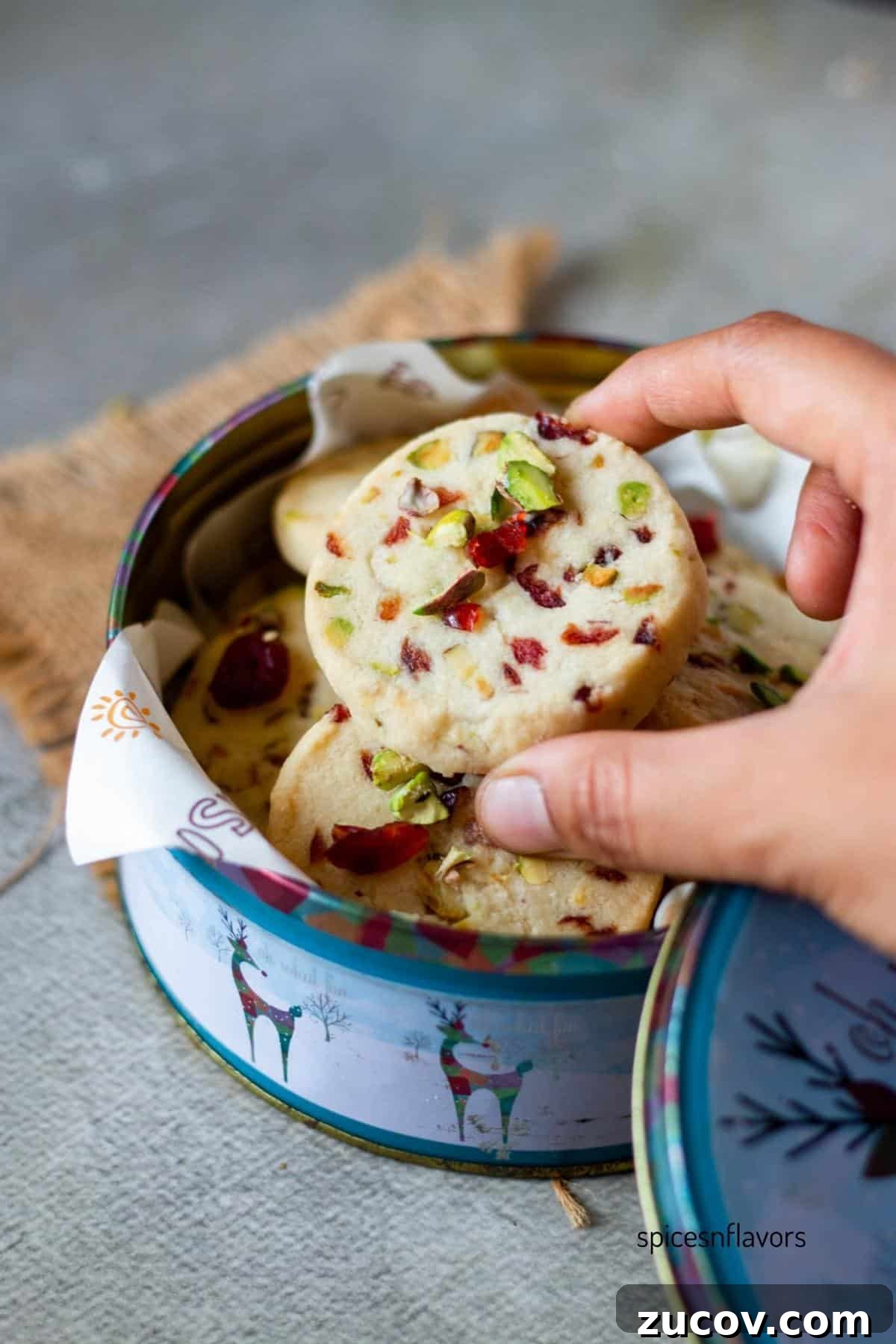 Cranberry Pistachio Shortbread Cookies (Egg-Free) 9 picking up cranberry pistachios shortbread cookies from cookie tin