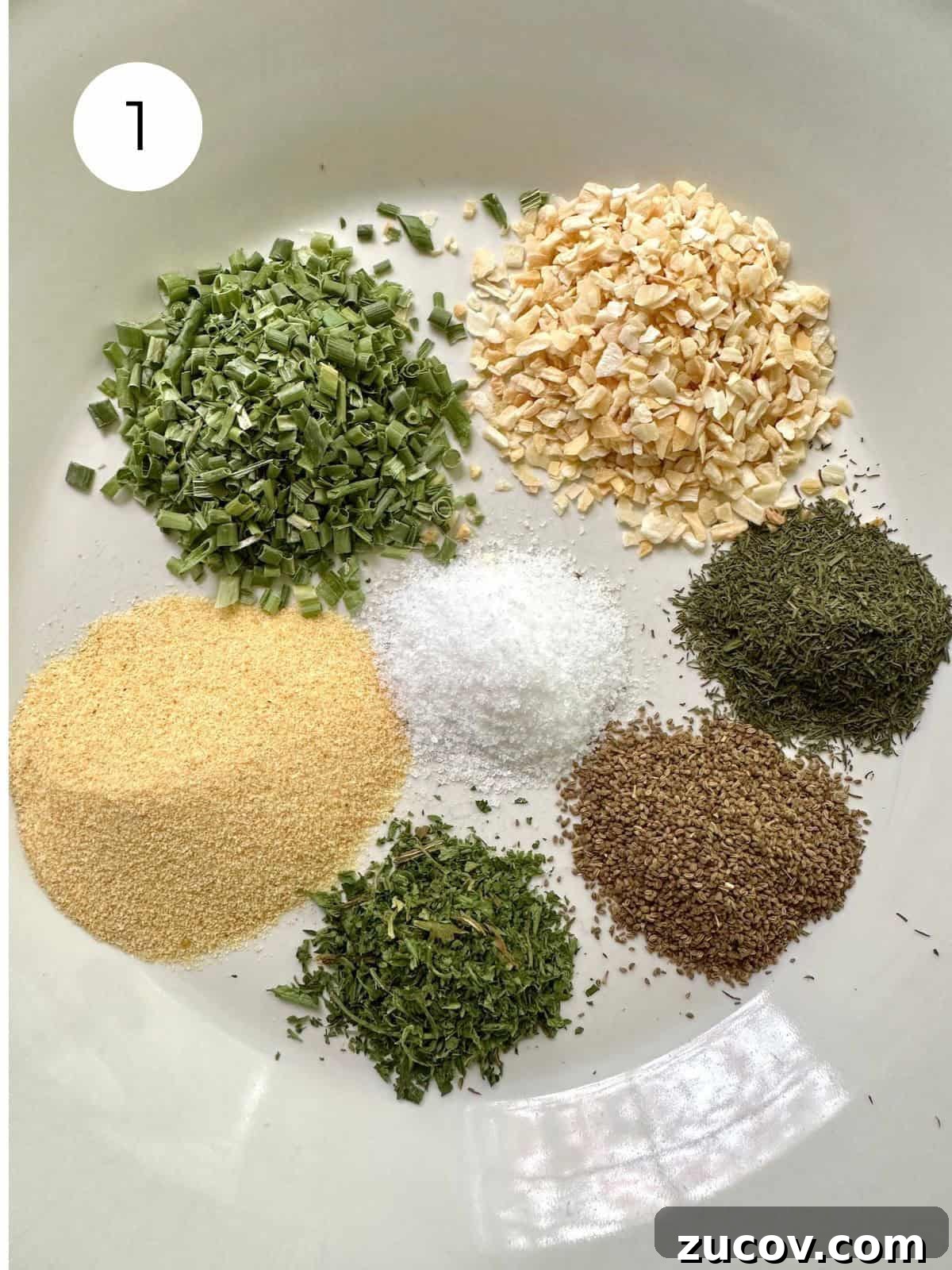 Creamy Herb and Garlic Dip Recipe for Parties and Snacks 4 Dried herbs and salt in small mounds on a plate.