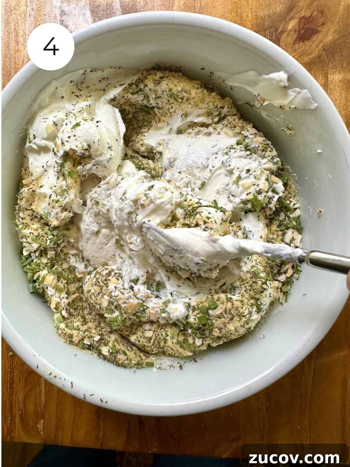 Creamy Herb and Garlic Dip Recipe for Parties and Snacks 7 Dried herbs mixed with sour cream in a bowl.