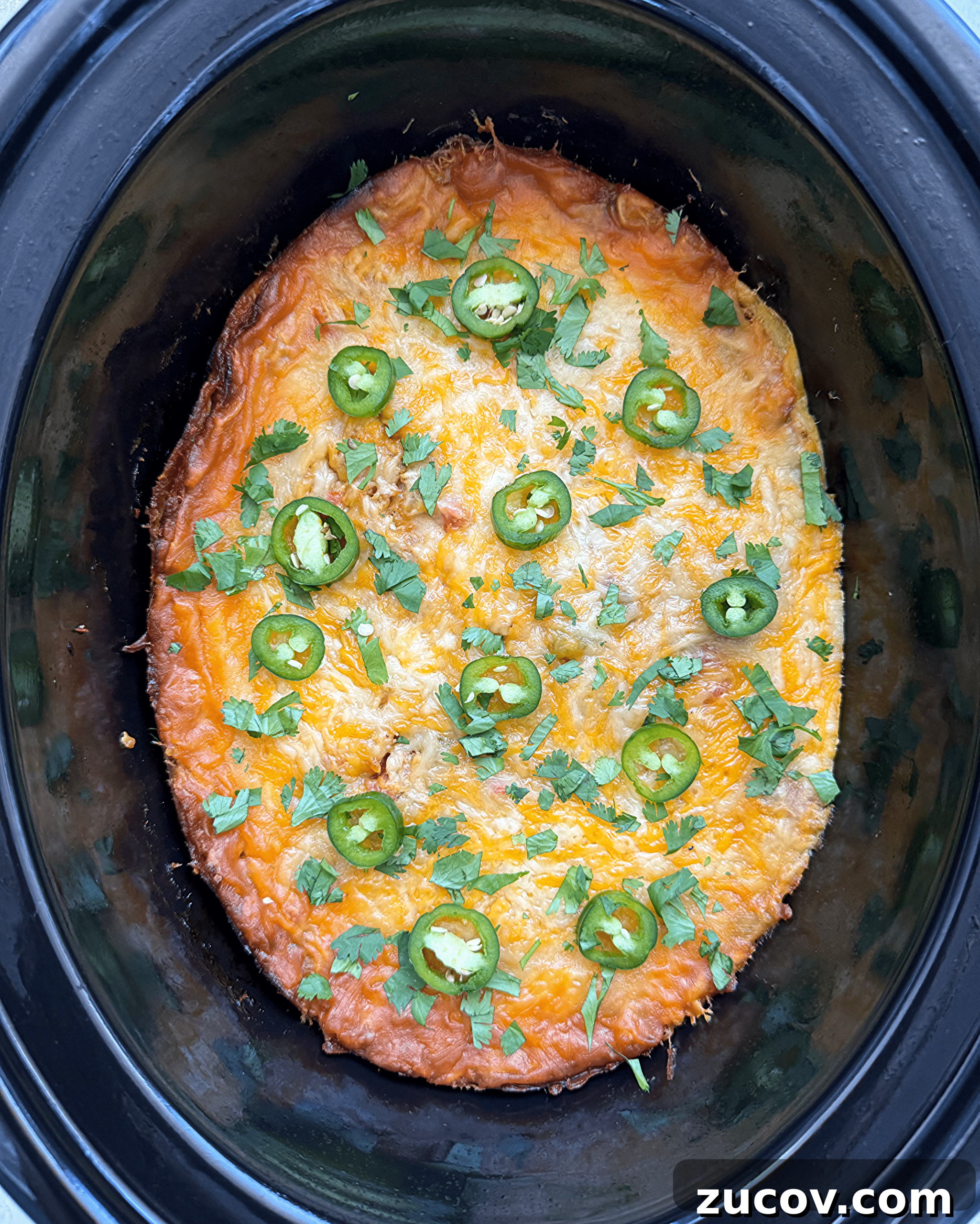Salsa Verde Chicken Casserole (Slow Cooker Recipe) 4 overhead shot of cooked salsa verde chicken casserole in a black slow cooker