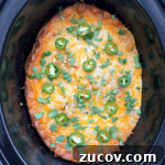 overhead shot of cooked salsa verde chicken casserole in a black slow cooker