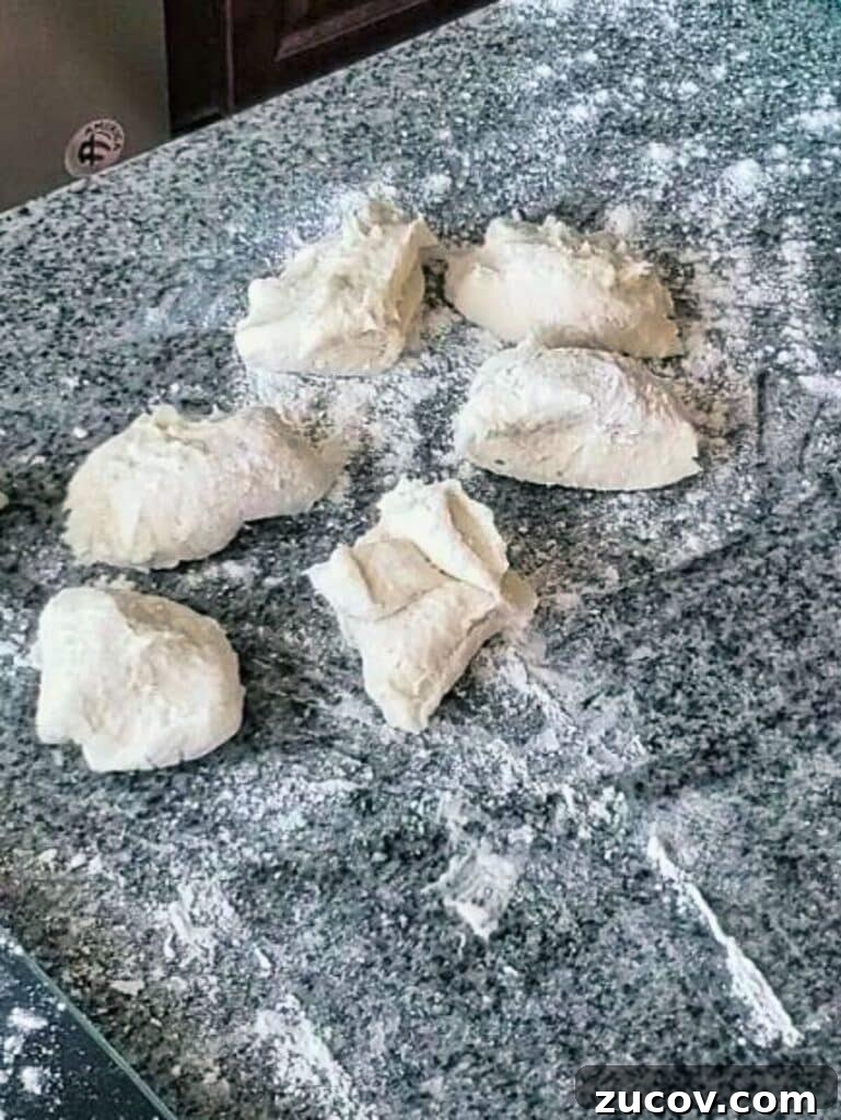 Crispy Gluten-Free French Rolls Recipe for Artisan Sandwiches 3 rolls divided into 2 ounce pieces on floured surface.