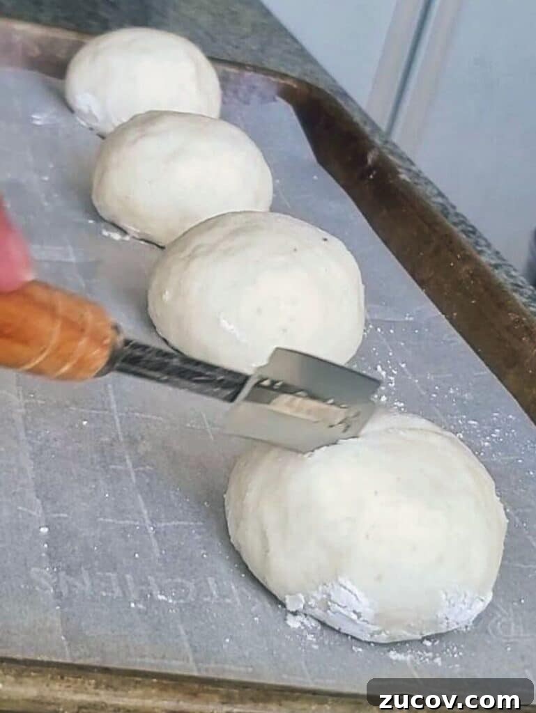 Crispy Gluten-Free French Rolls Recipe for Artisan Sandwiches 6 slashing roll with bread lame.