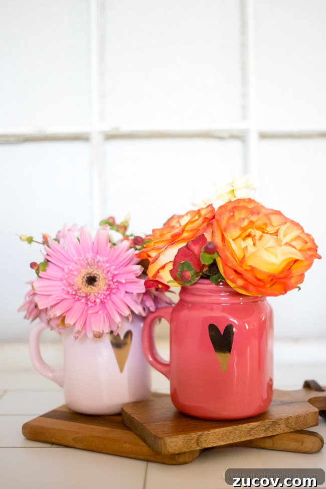Two mugs with hearts with flowers arranged in it.