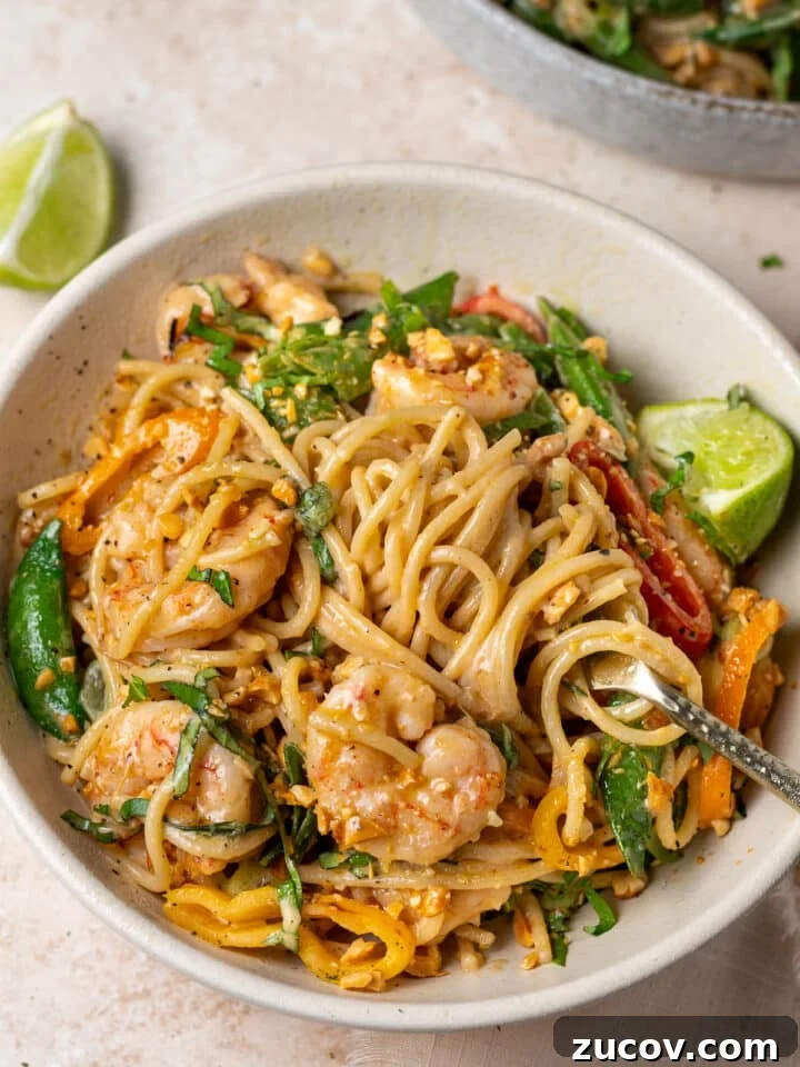 Shrimp peanut noodles with snap peas, mini peppers, Thai basil, and chopped peanuts