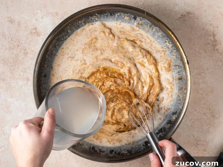 Adding pasta water to creamy peanut sauce 