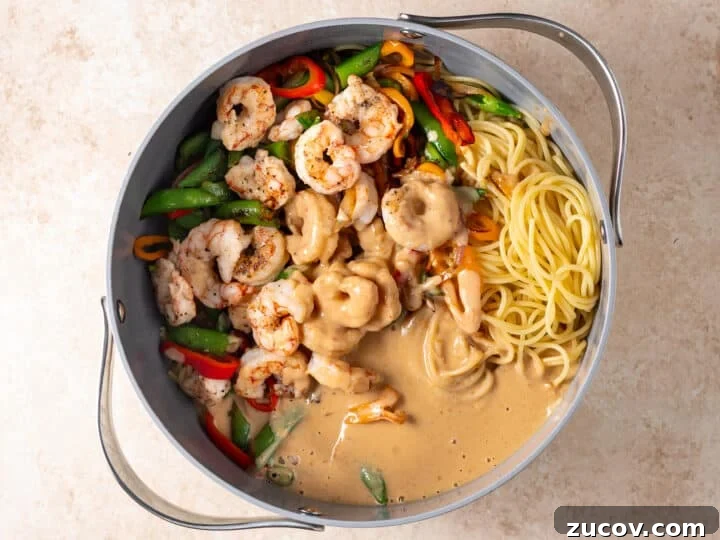 Shrimp, vegetables, spaghetti, and creamy peanut sauce