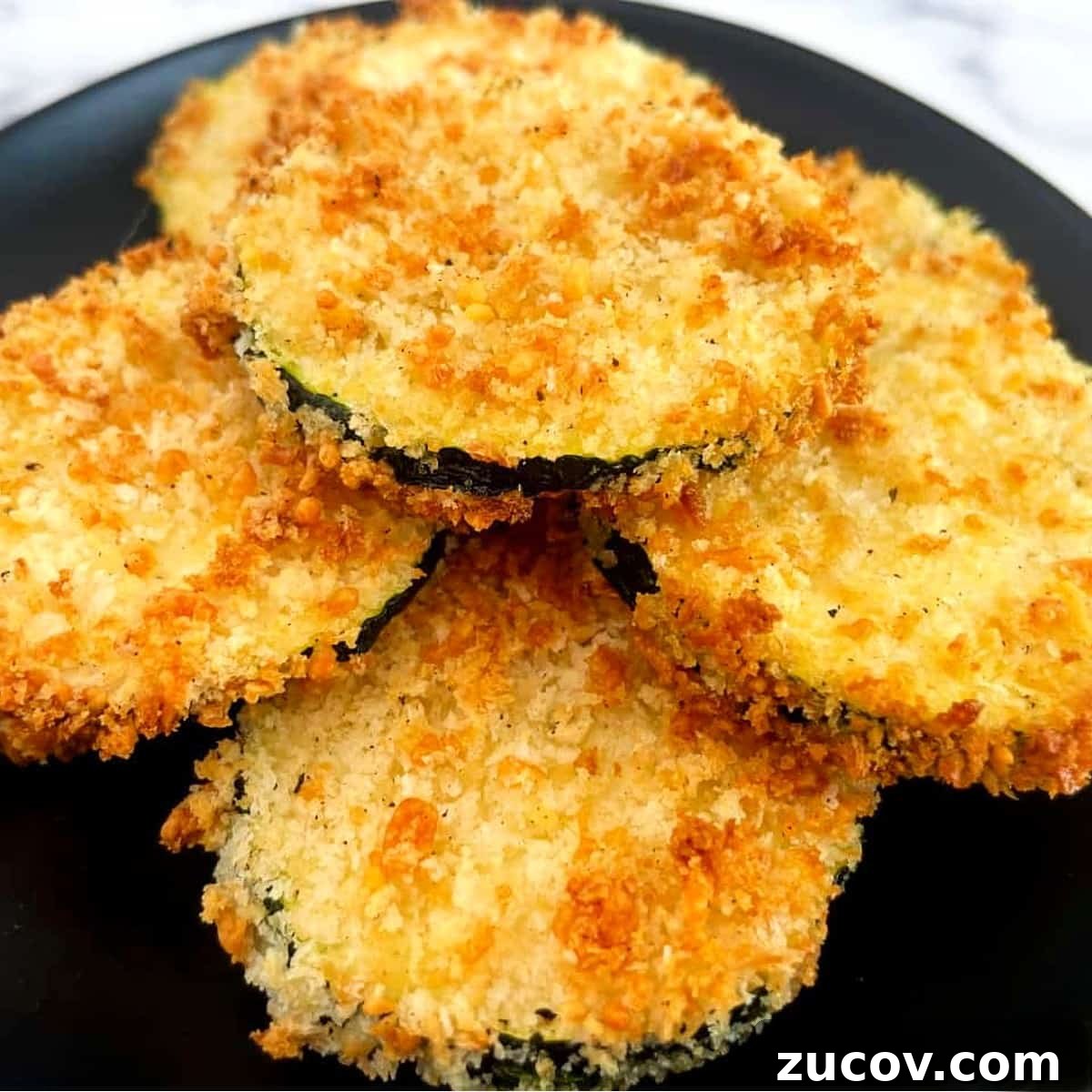 Crispy Air Fryer Zucchini Chips Recipe 11 air fryer zucchini stacked on a plate