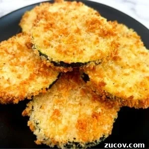 Crispy Air Fryer Zucchini Chips Recipe 12 air fryer zucchini stacked on a plate