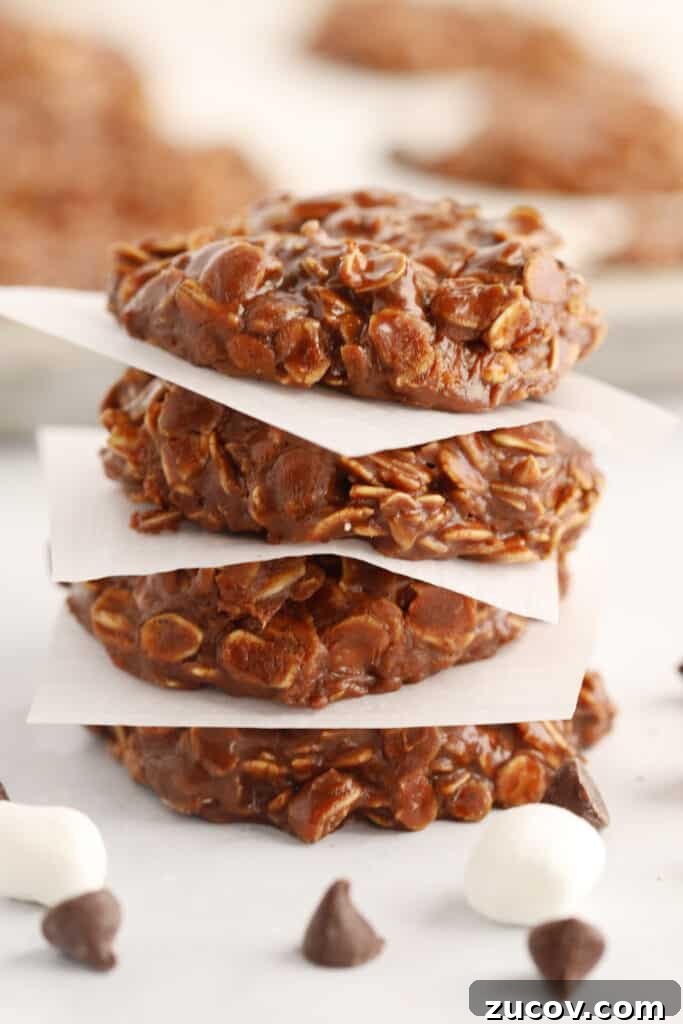 No-Bake Chocolate Oatmeal Cookies: Quick Refrigerator Treats 3 recipe for no bake chocolate cookies without peanut butter on parchment squares in a stack. These No bake chocolate oatmeal cookies are so delicious and chewy.